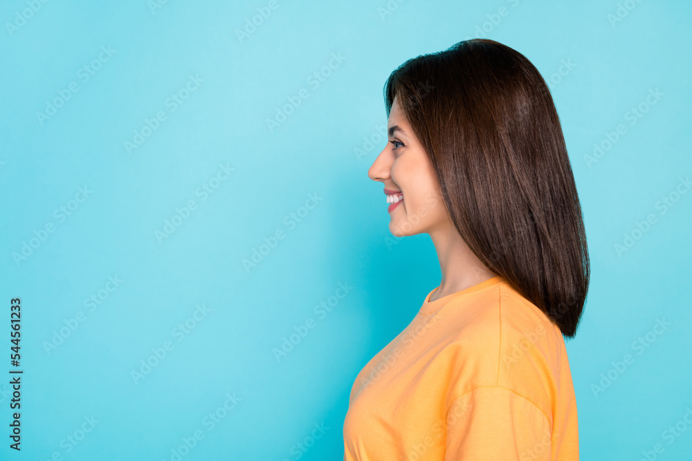 Profile photo of nice satisfied young lady beaming smile look empty space isolated on blue color background Profile photo of nice satisfied young lady beaming smile look empty space isolated on blue color background