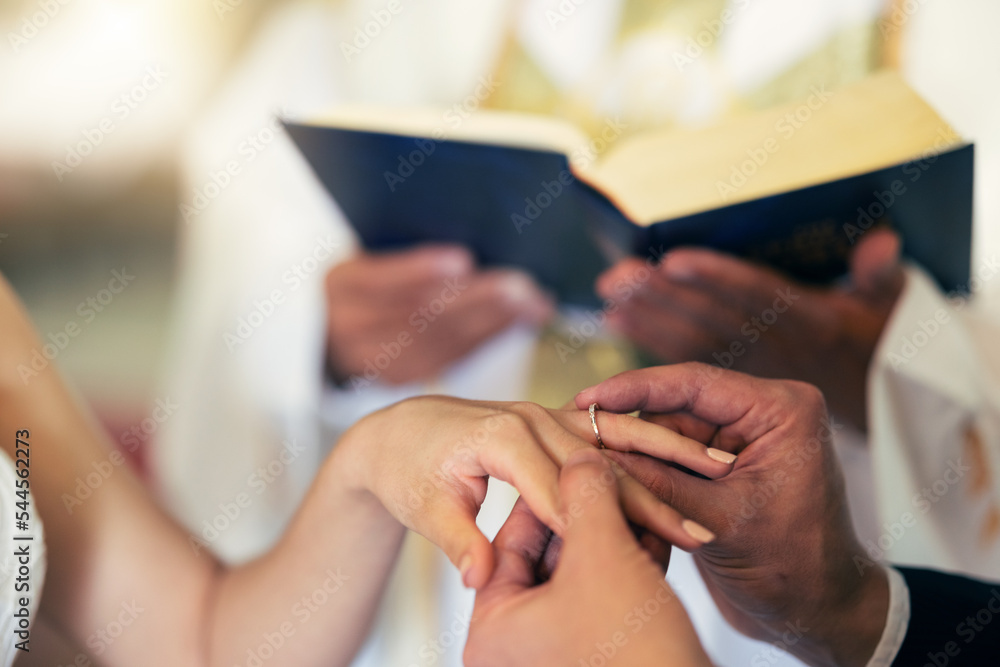 Couple hands with ring, wedding and marriage in church with priest and bible in traditional ceremony. Commitment, love and jewelry, man and woman together with trust and jewellery with bride.