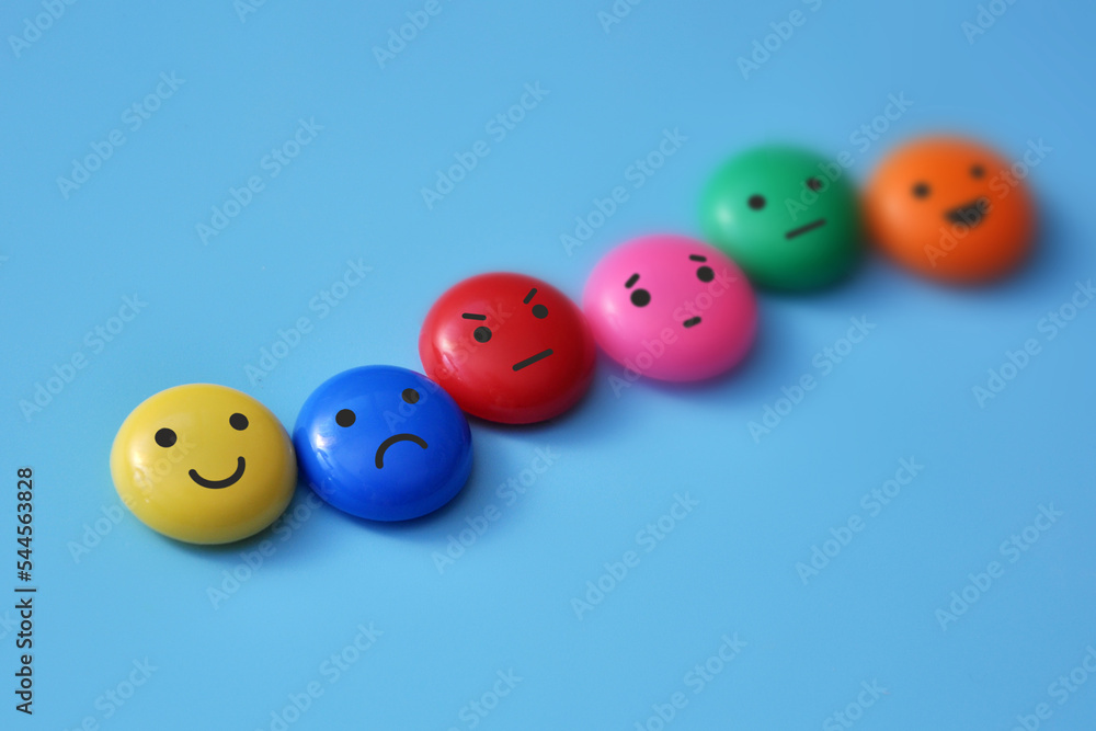 A variety of human emotions: joy, serenity, anger, sadness on colored balls A variety of human emotions: joy, serenity, anger, sadness on colored balls