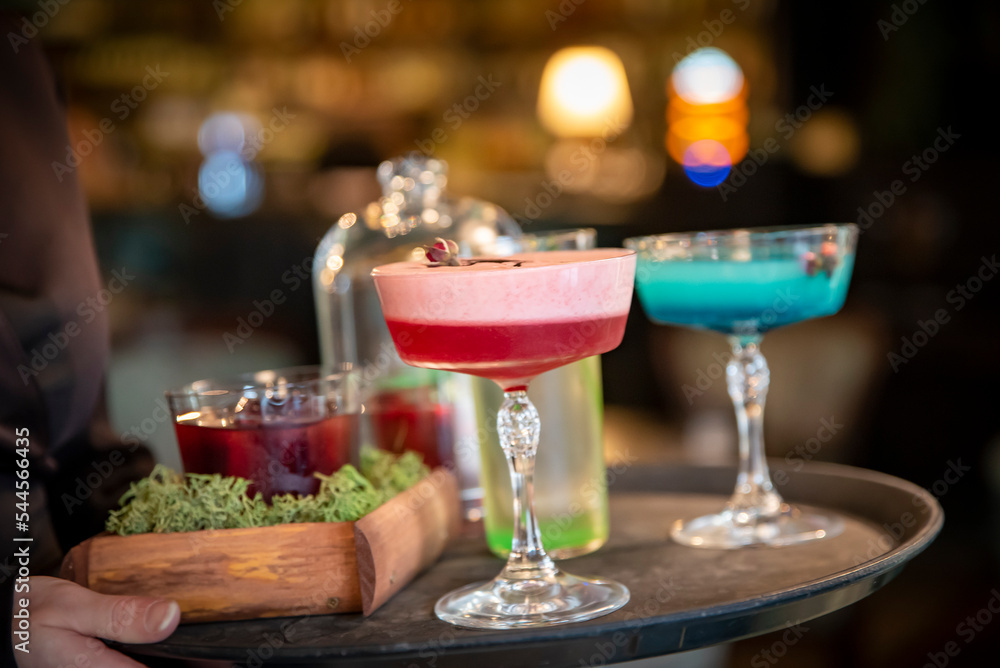 glasses alcohol cocktail set on a waiter tray in bar