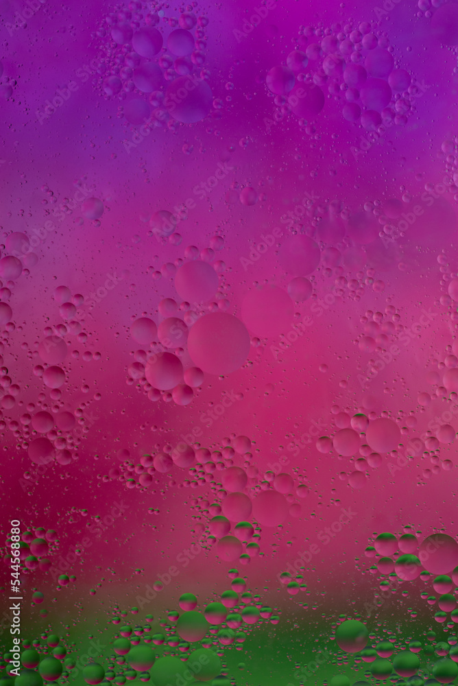 Watercolor transition of purple to fuchsia and green background for oil drops Watercolor transition of purple to fuchsia and green background for oil drops