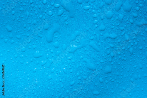 Water drops on a blue leather surface as an abstract background