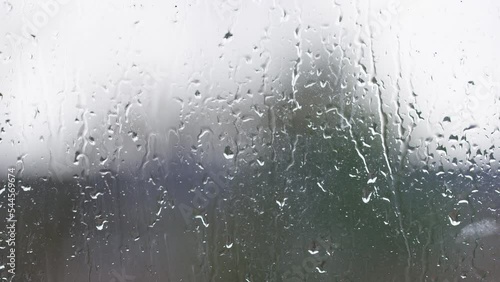 Blurred window view of wet weather outside, background for text