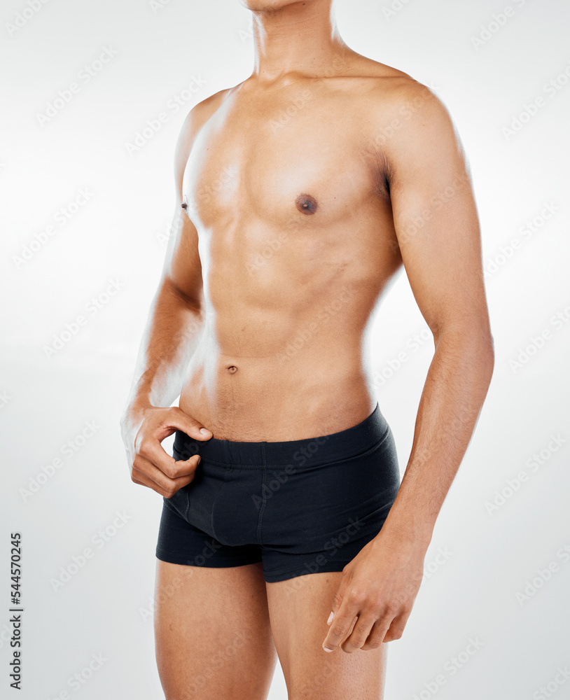 Fototapeta premium Body, fitness and health with a topless man model posing in underwear in studio on a gray background for wellness. Skin, healthy and natural with a muscular male athlete inside to promote lifestyle