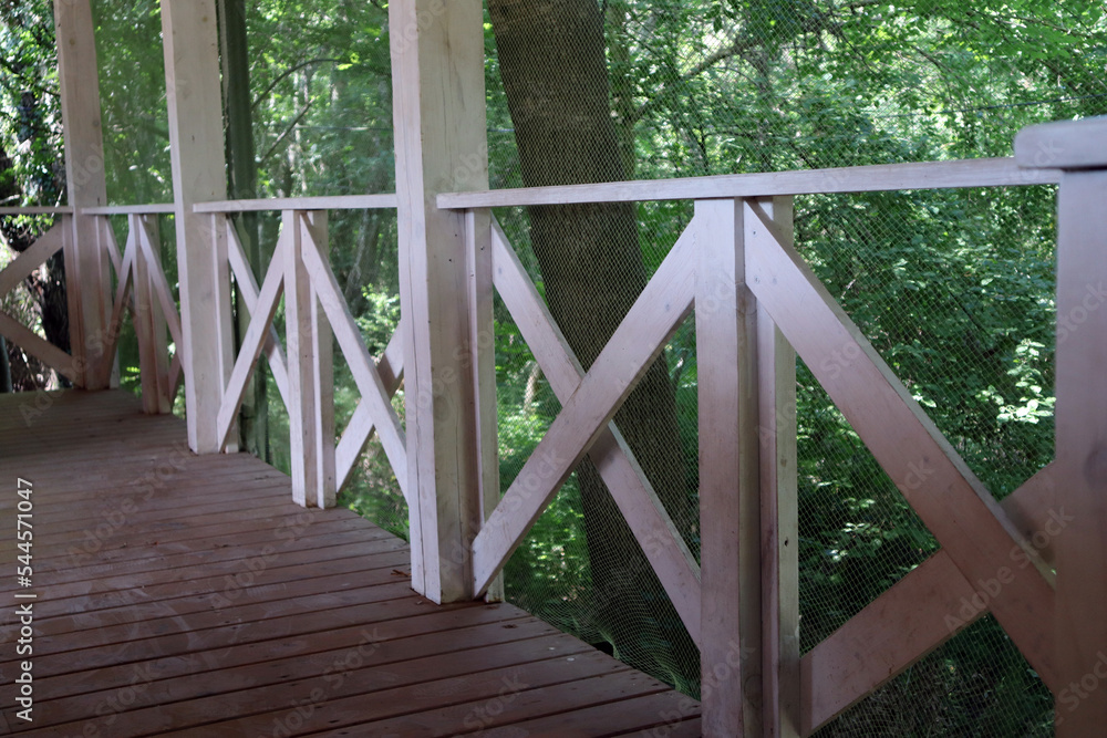 White wooden terrace. Railing. House in the green forest White wooden terrace. Railing. House in the green forest