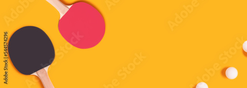 Banner with tennis rackets and white balls on a bright yellow background. Ping pong compsition with place for text. photo