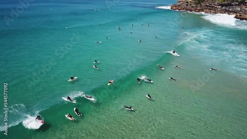 surfers surfing at busy freshwater and manly beaches weekend school holidays photo