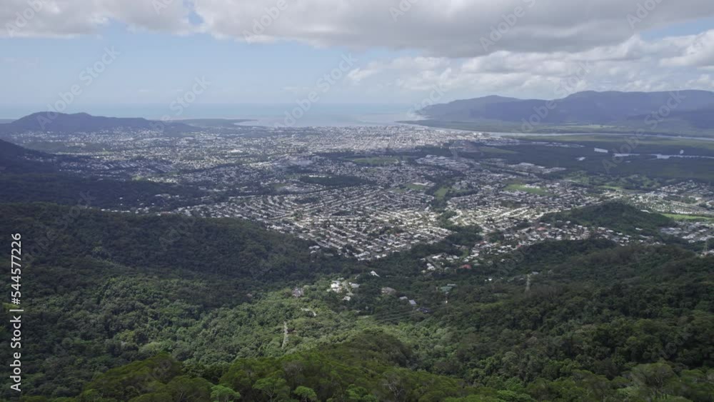 Panoramic View Of City Cairns Surrounded With Lush Mountains And Vegetation In Australia - drone shot Panoramic View Of City Cairns Surrounded With Lush Mountains And Vegetation In Australia - drone shot