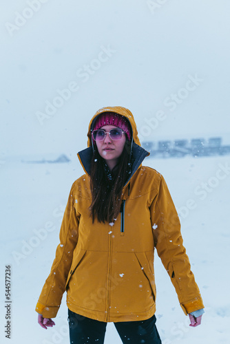 Obraz na płótnie woman in the snow with yellow coat, hat and sunglasses w salonie