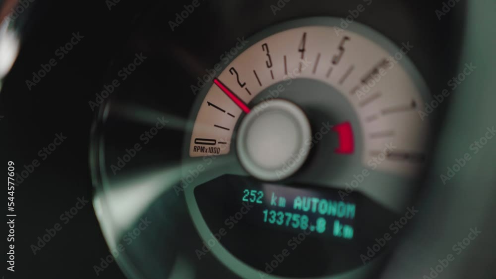 The red needle on the speedometer in the wheelhouse of a luxury car The red needle on the speedometer in the wheelhouse of a luxury car