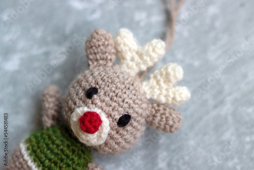 Crochet amigurumi Christmas toy. Close up photo of hand made  staffed doll. Christmas decoration ideas. 