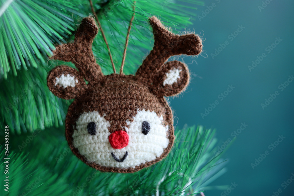 Cute hand made Christmas ornament. Crochet Reindeer close up photo. Cozy winter present ideas. 