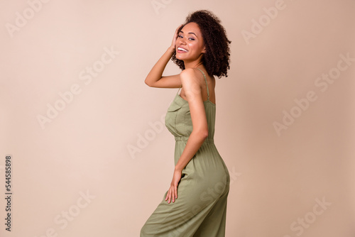 Profile photo of brunette millenial lady wear khaki overall isolated on beige color background
