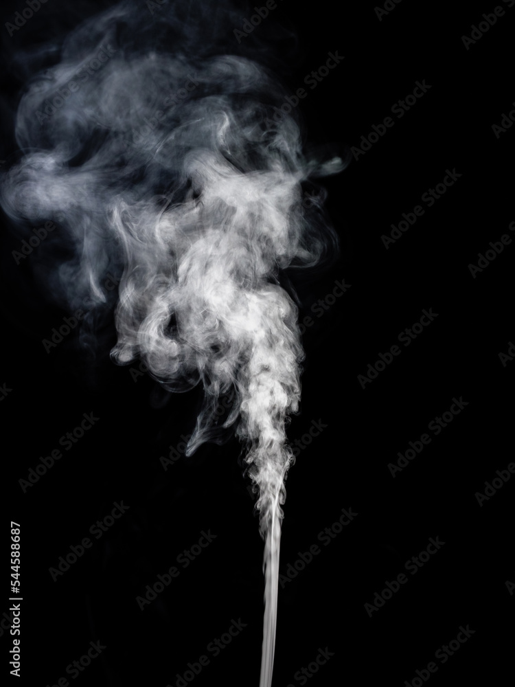A jet of white smoke rises, streams and forms tubers on a black A jet of white smoke rises, streams and forms tubers on a black