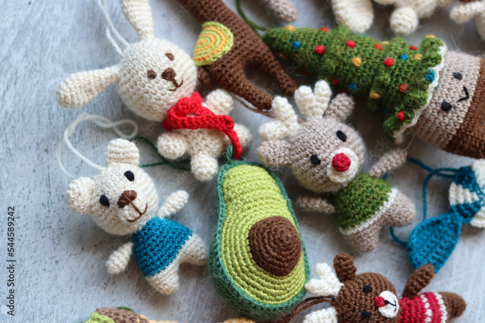 Christmas crochet patters. Cute crochet toys top view photo. Beautiful amigurumi animals. Home made Christmas gifts. Light grey background with copy space. 
