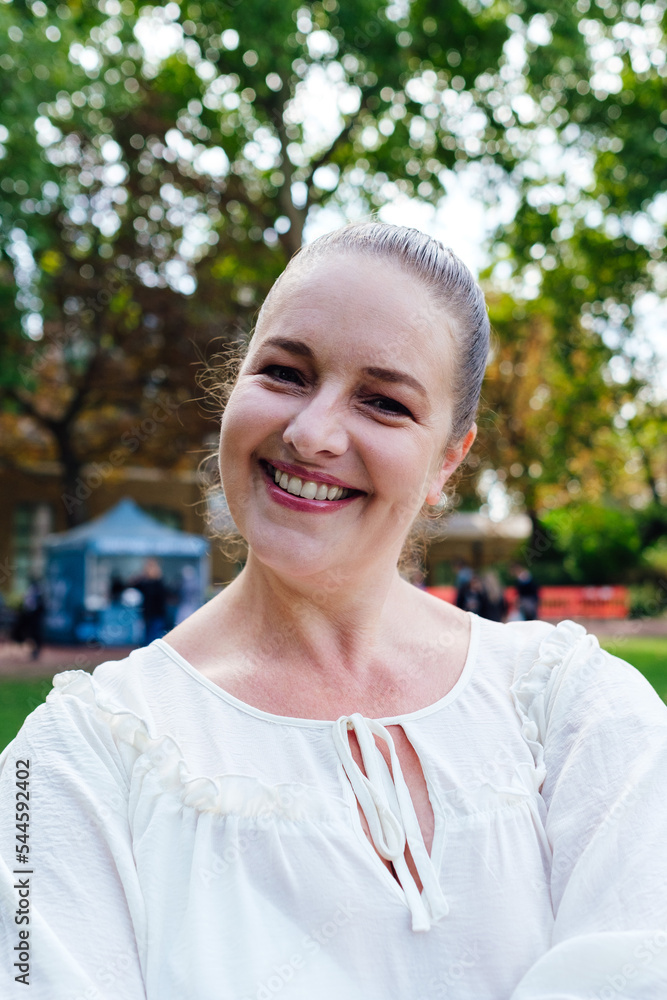 Portrait of confident senior woman standing in the park with her arms crossed. Portrait of confident senior woman standing in the park with her arms crossed.
