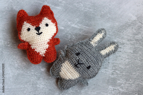 Christmas crochet patters. Cute crochet toys top view photo. Beautiful amigurumi animals. Home made Christmas gifts. Light grey background with copy space. 