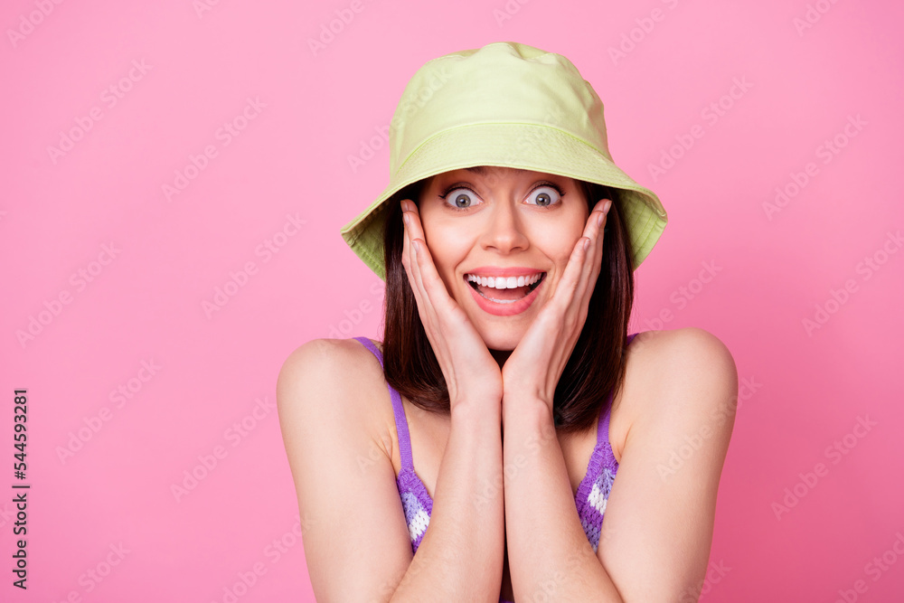 Photo of impressed cheerful lady hands touch cheeks toothy smile isolated on pink color background Photo of impressed cheerful lady hands touch cheeks toothy smile isolated on pink color background