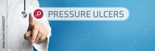 Pressure ulcers (bedsores). Doctor in smock points with his finger to a search box. The term is in focus. Symbol for illness, health, medicine