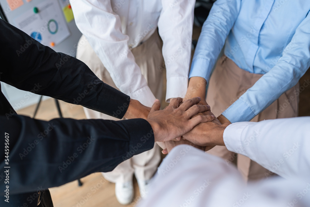 Group of business people putting their hands working together on wooden background in office. group support teamwork agreement concept Group of business people putting their hands working together on wooden background in office. group support teamwork agreement concept