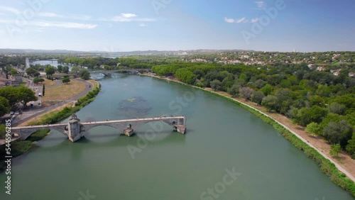 The drone aerial footage of Pont Saint Benezet bridge and Rhone river in Avignon. Avignon is a city on the Rhone river in southern France. The Pont Saint-Bénézet also known as the Pont d'Avignon.