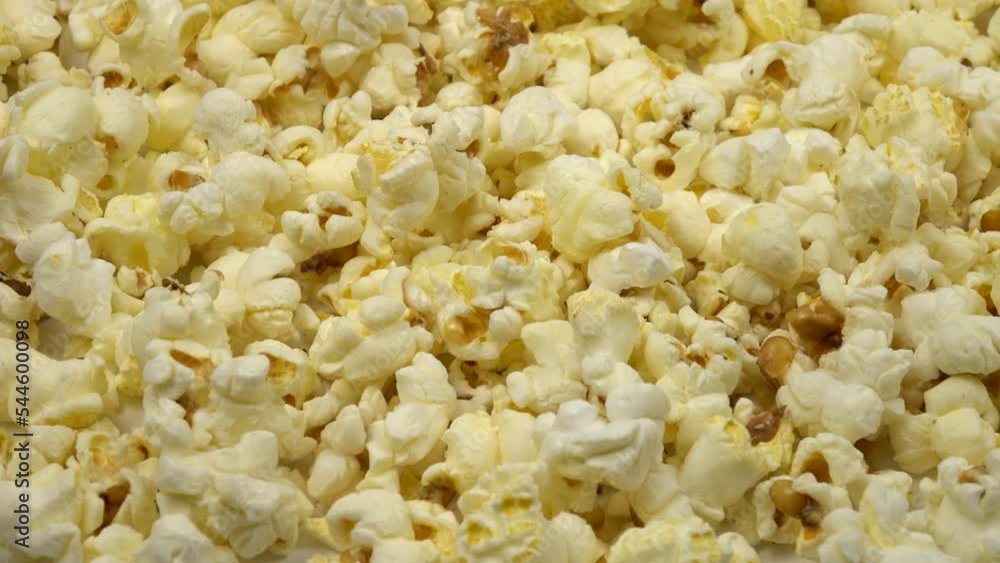 White popcorn falling on a heap of pop corn, background White popcorn falling on a heap of pop corn, background