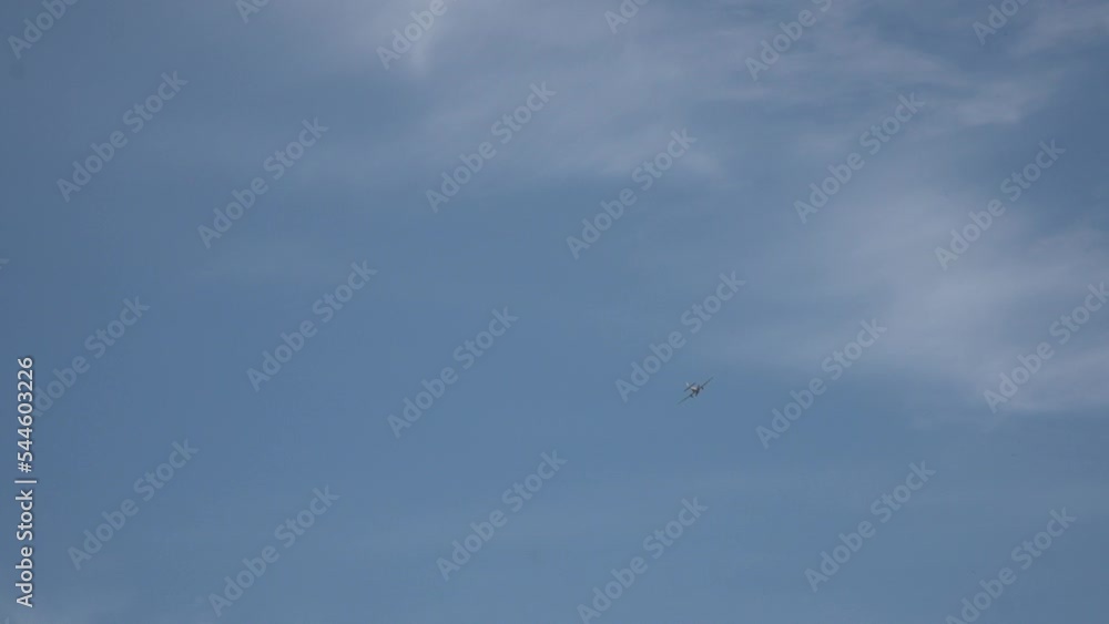 Long shot of flying away small-seat plane in patrially cloudy sky when sunny summer. Plane owned to aircraft school Long shot of flying away small-seat plane in patrially cloudy sky when sunny summer. Plane owned to aircraft school