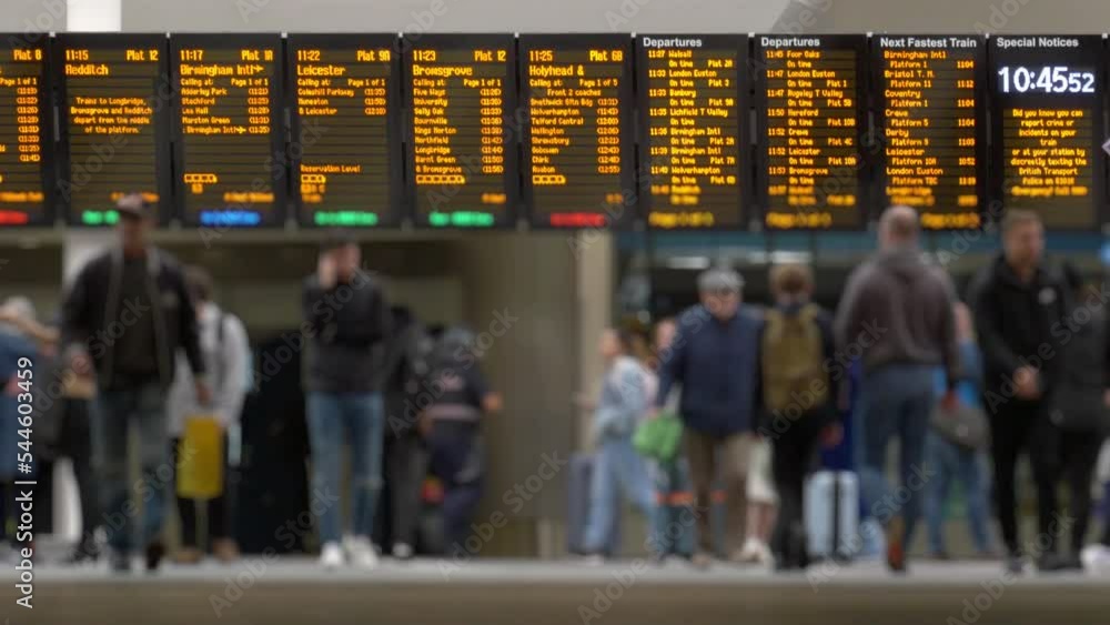 UK railway station concourse showing information boards and people.
Telephoto shot of a train station concourse blurred to anonymize people.
