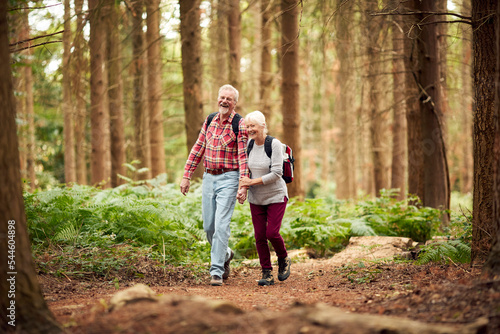 Loving Retired Senior Couple Hiking In Woodland Countryside Together © Monkey Business