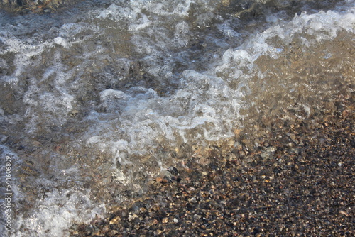 Seashore covered by a wave close up view from above
