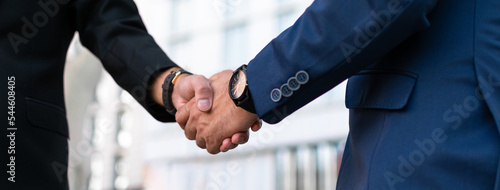 successful contract negotiate and handshake concept, two businessman shake hand with partner to celebration partnership, teamwork, business deal in room meeting after success communication, agreement