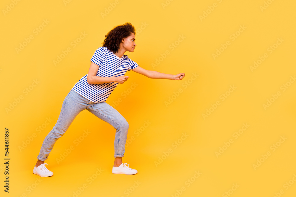 Full length profile photo of focused concentrated person arms hold pull empty space rope isolated on yellow color background