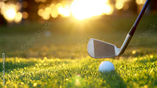 Golf ball close up on tee grass on blurred beautiful landscape of golf background. Concept international sport that rely on precision skills for health relaxation....