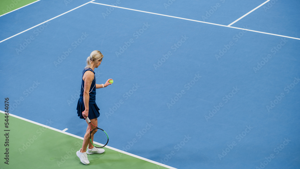 Female Tennis Player Preparing for Hitting a Ball with a Racquet During Championship Match. Professional Woman Athlete About to Strike. World Sports Tournament. High Angle Wide Shot. Female Tennis Player Preparing for Hitting a Ball with a Racquet During Championship Match. Professional Woman Athlete About to Strike. World Sports Tournament. High Angle Wide Shot.