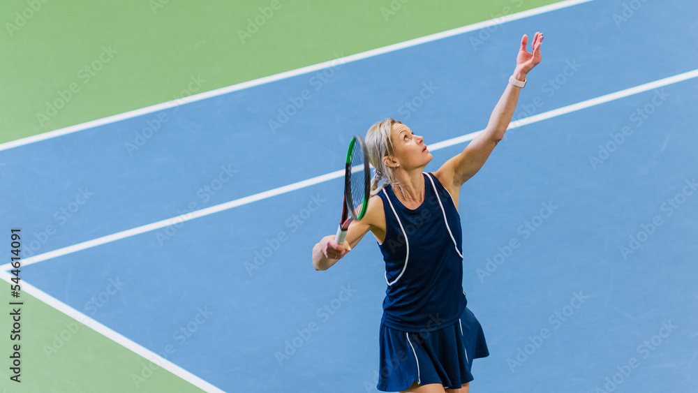 Female Tennis Player About to Serve by Throwing a Ball in the Air During Championship Match. Technical Woman Athlete Preparing to Strike. World Sports Tournament. High Angle Medium Photo.