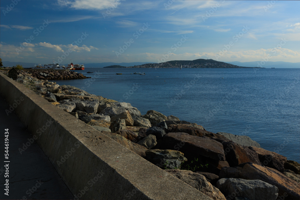 Sea coast, promenade for walks and stones, breakwaters and ships. On the streets in Istanbul, public places.