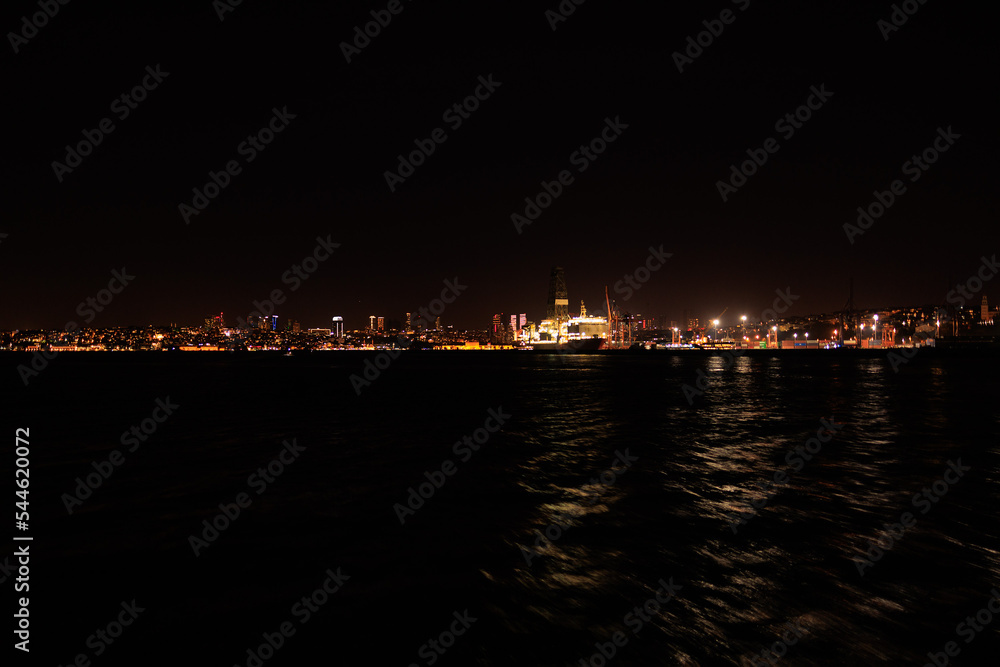 Night sky and light over the sea. Silhouette of the city of Istanbul.