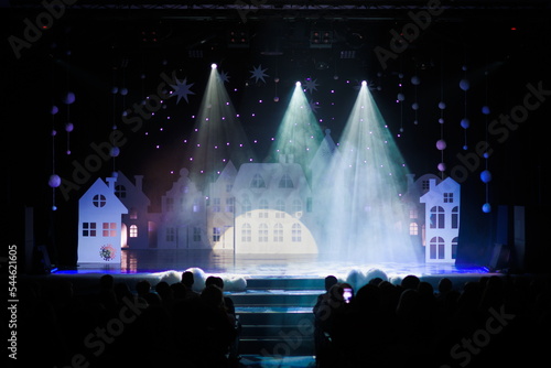 The stage of the theater illuminated by spotlights from the auditorium