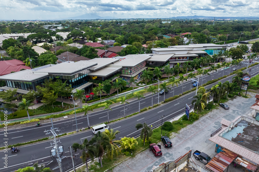 Alabang, Muntinlupa, Philippines - Aerial of Alabang West Parade, a strip mall with the posh Ayala Alabang Village behind.
