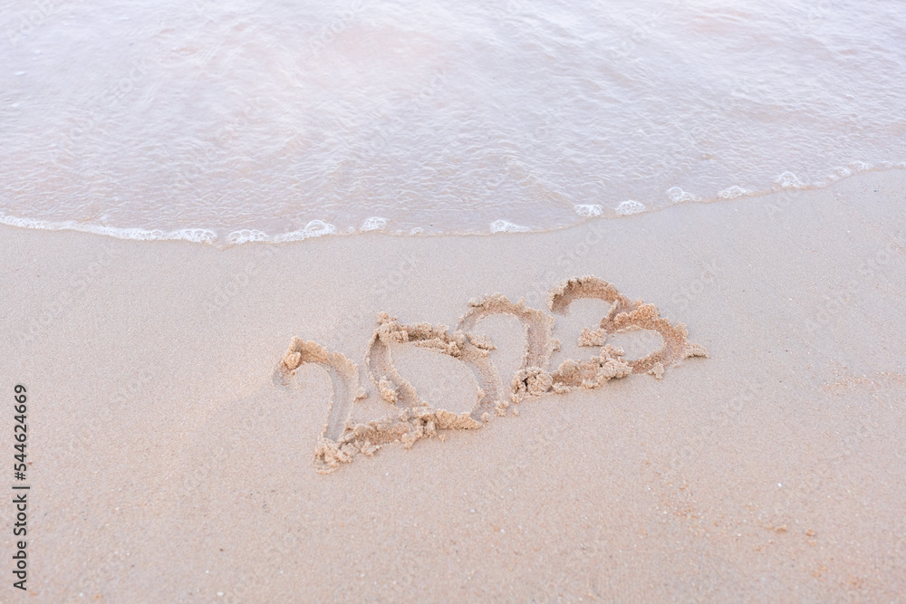 2023 happy New Year coming concept. White waves are lapping towards the shore