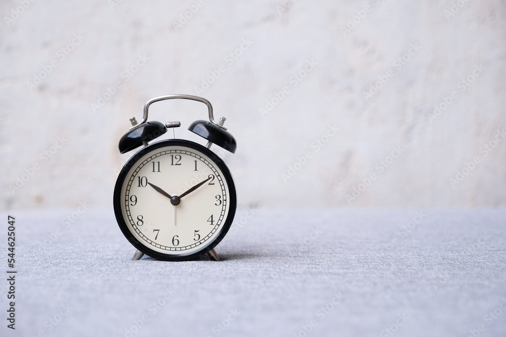 alarm clock on white bed. morning time. alarm clock on white bed. morning time.