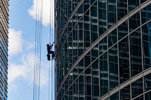 Wallpaper Mural Industrial mountaineering. Window cleaner performs work between two skyscrapers Torontodigital.ca