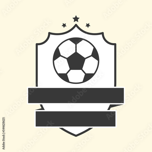 Black And White Soccer Ball With Blank Ribbon Covering Shield On Cosmic Latte Background.