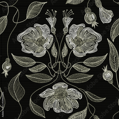 Embroidered flowers and leaves ornament on a dark background.