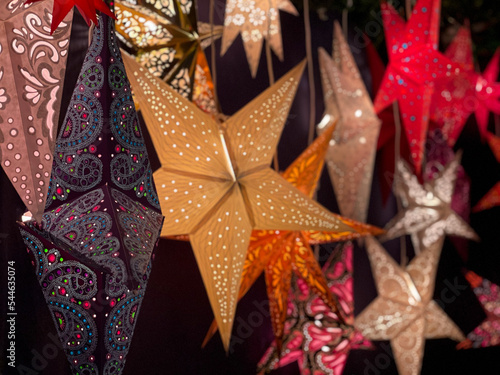 Traditional Christmas stars lanterns decorative lamps with open work patten isolated on black background close up