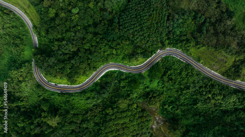 beautyfull curve road on green forest in the rain season background, rural routes connecting cities in the north of thailand © SHUTTER DIN