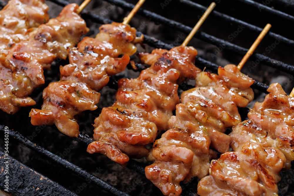 Grilled pork skewers on the stove. Traditional Thai-style grilled pork. Delicious and popular menu. Thai called 'Moo Ping'. Close-up photo. Asia food, Thai food.