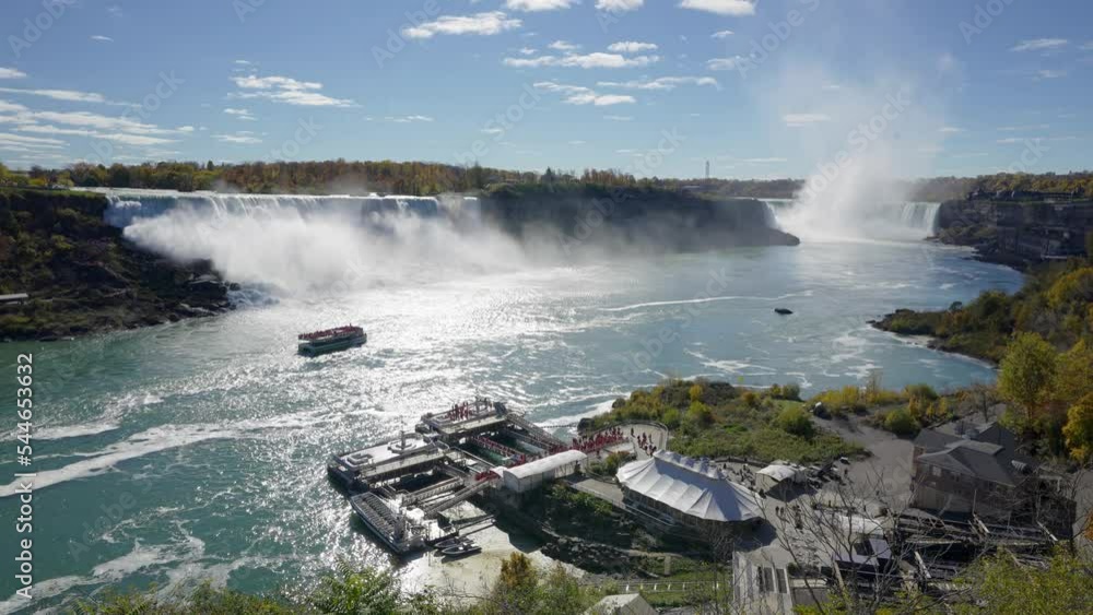 Niagara Falls American Falls and Horseshoe Falls in a sunny day in autumn foliage season. Niagara City Cruise Boat Tour.
Niagara Falls American Falls and Horseshoe Falls in a sunny day in autumn foliage season. Niagara City Cruise Boat Tour.