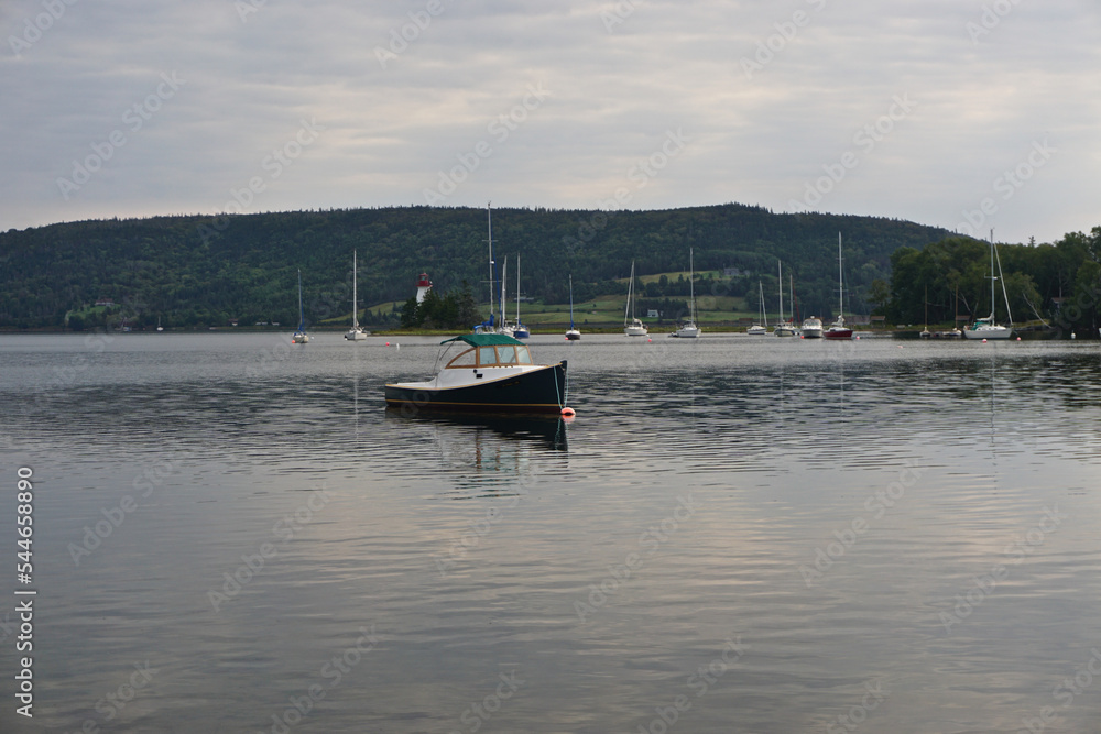 Baddeck, Nova Scotia, Canada: Small boats anchored in Bras dOr Lake on Cape Breton Island, with the Kidston Island Lighthouse (1912) in the background.