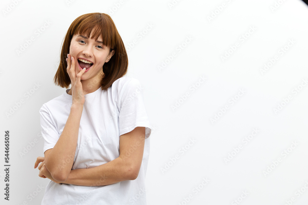 beautiful, playful, thoughtful woman stands holding her hand near her face in a relaxed pose, standing on a white background. Horizontal photo with an empty space for inserting an advertising layout beautiful, playful, thoughtful woman stands holding her hand near her face in a relaxed pose, standing on a white background. Horizontal photo with an empty space for inserting an advertising layout